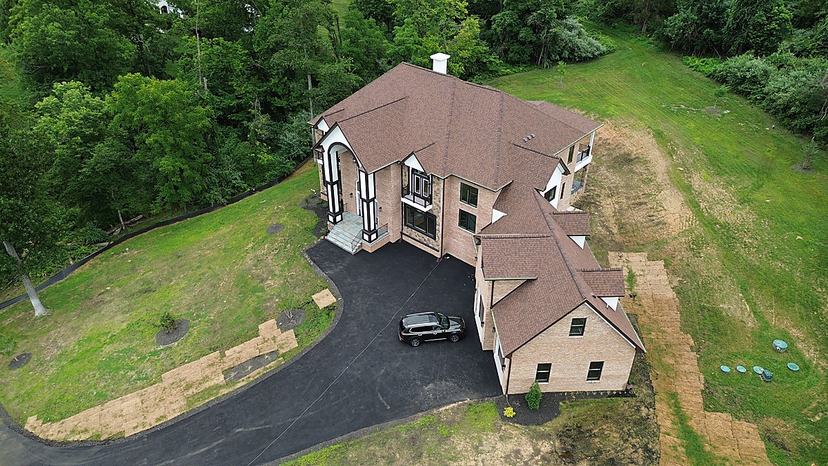 Aerial oblique view of a new construction brick colonial in Loudoun County, Virginia