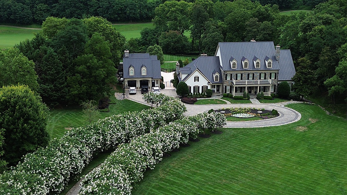 Aerial view of a Northern Virginia estate with circular drive and lush summer grounds